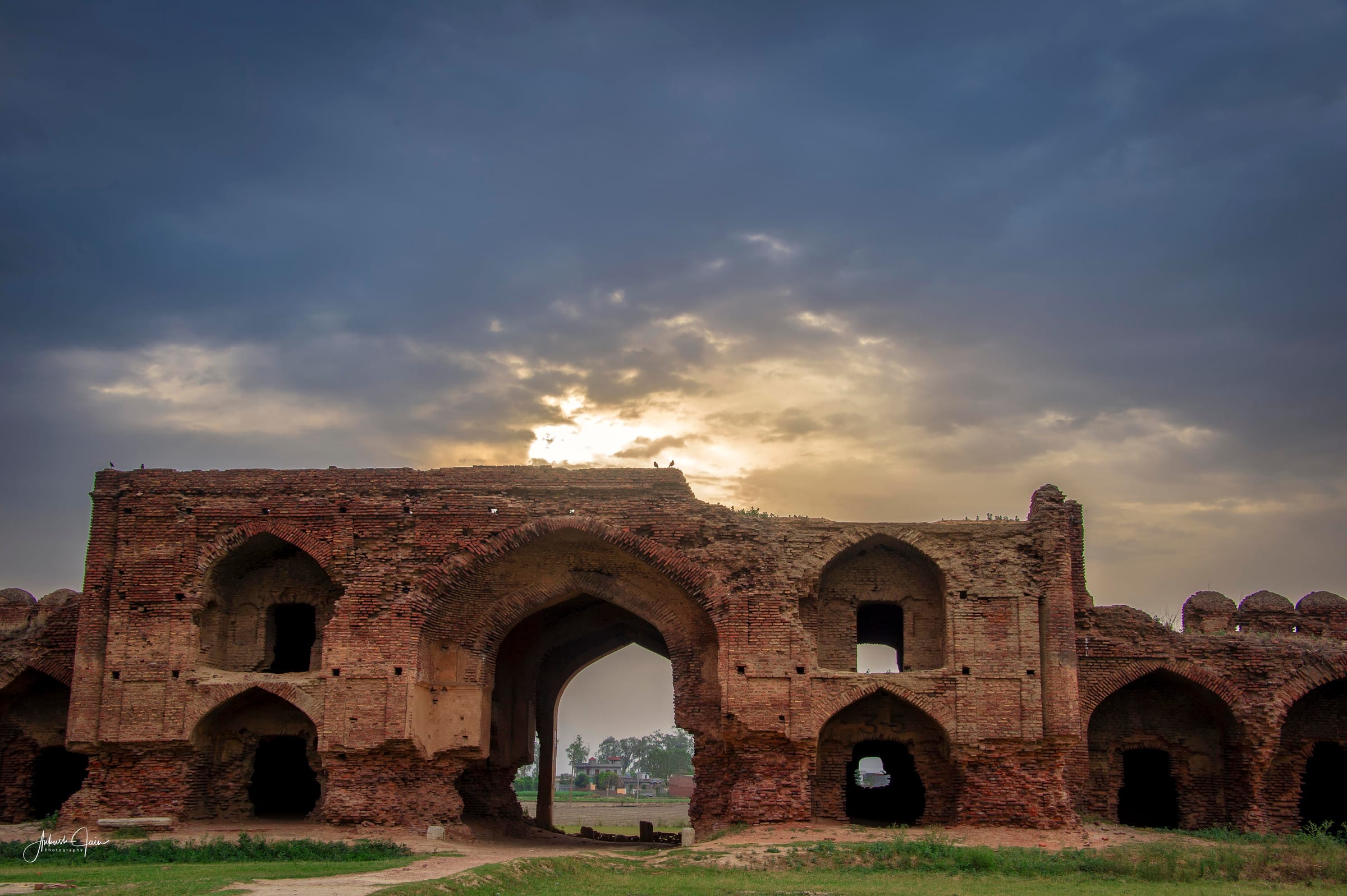 Sunset through the arches of Serai Lashkari Khan, a crumbling Mughal-era serai