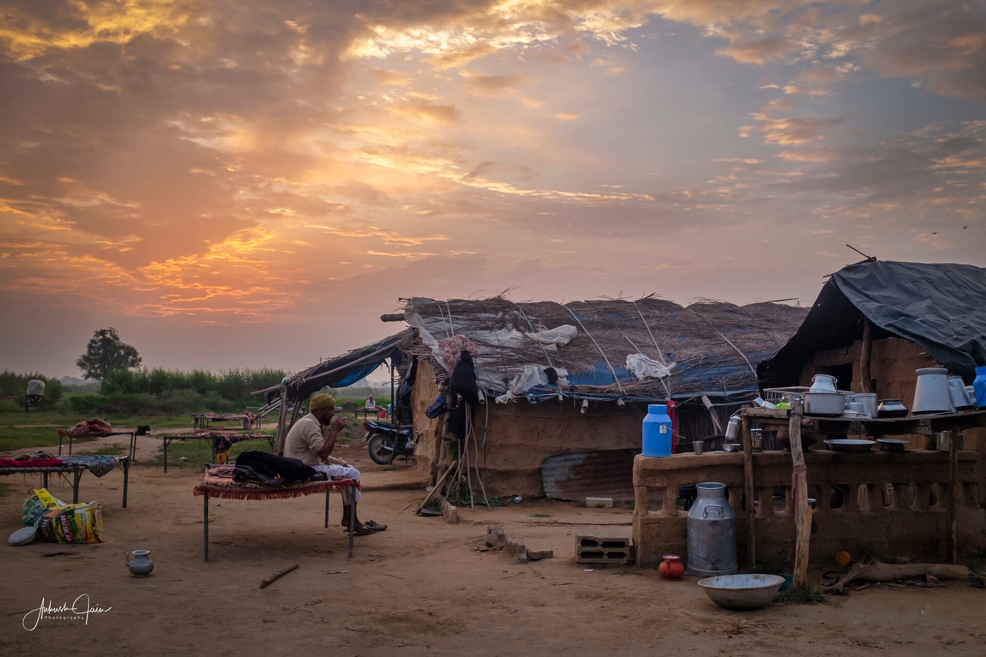 Gujjar at his morning chores outside the dera, village Deatwal, dramatic dawn sky