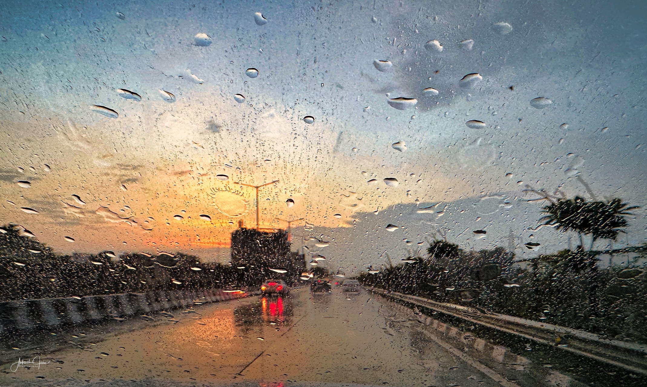 Rainy windshield view along Canal Road at dusk, Ludhiana
