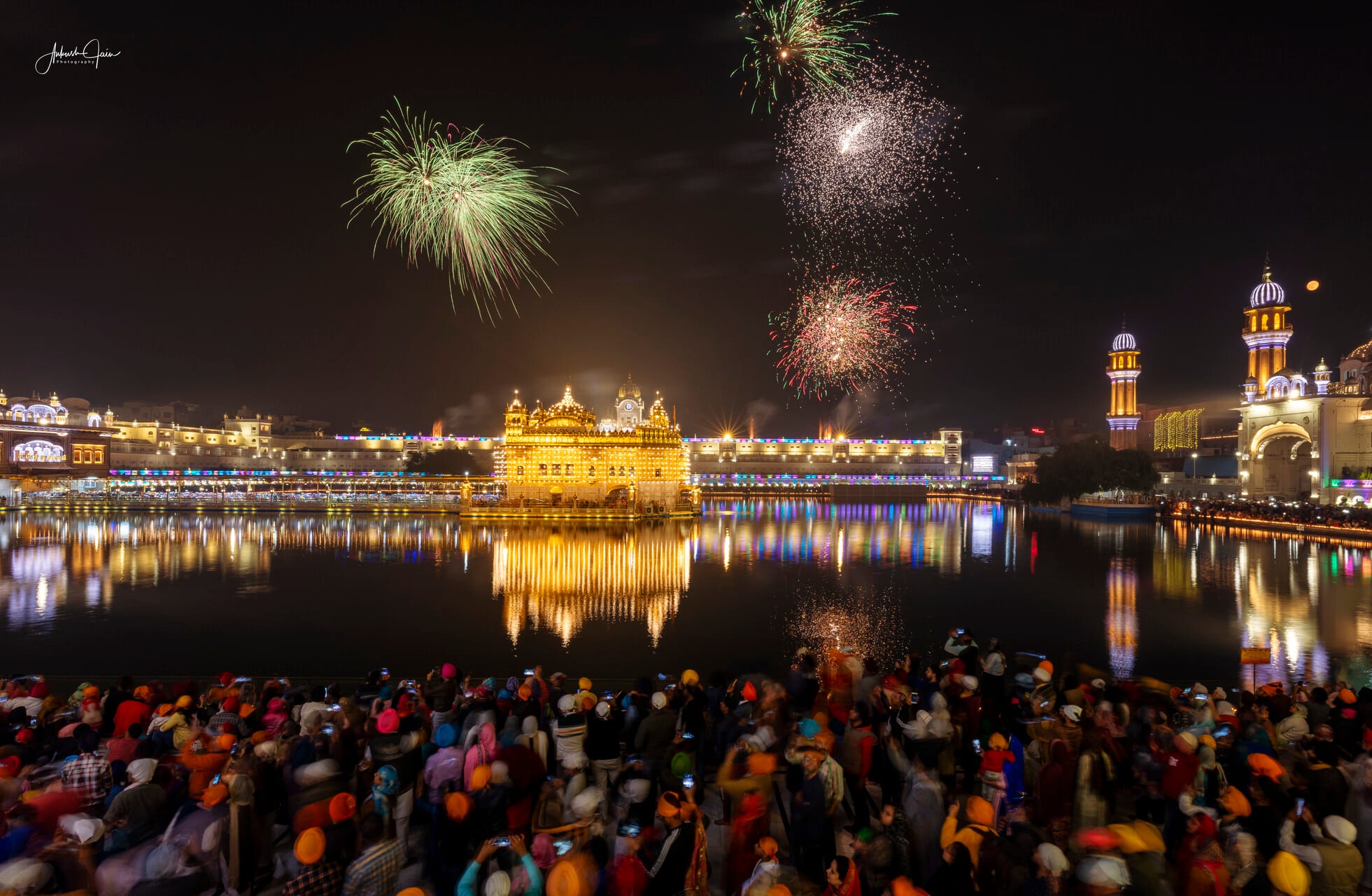 Fireworks burst over Harmandir Sahib on Gurpurab as crowds watch from the parikrama