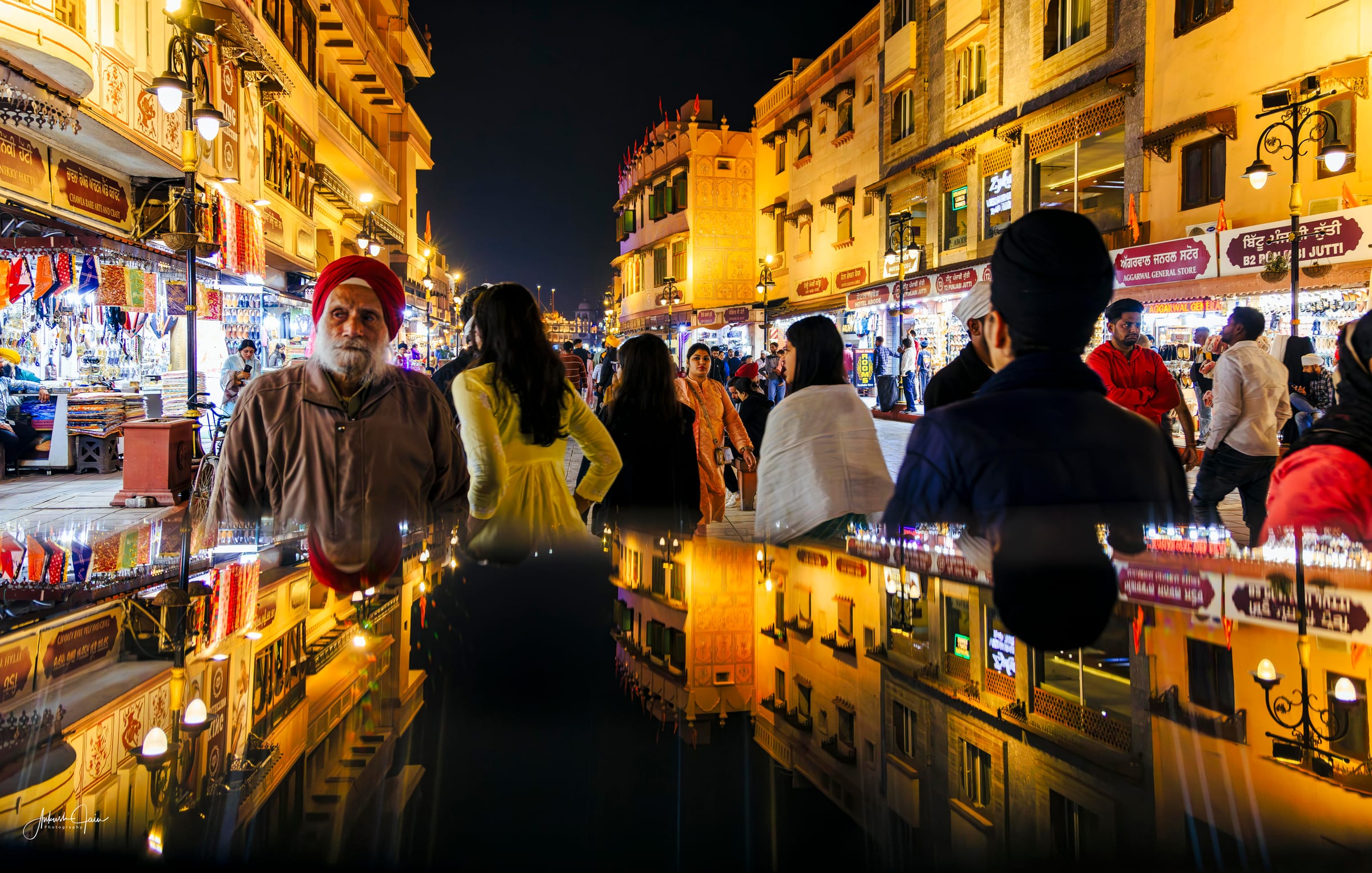 Night reflection of an elderly Sikh man amid bazaar crowds, Heritage Street Amritsar