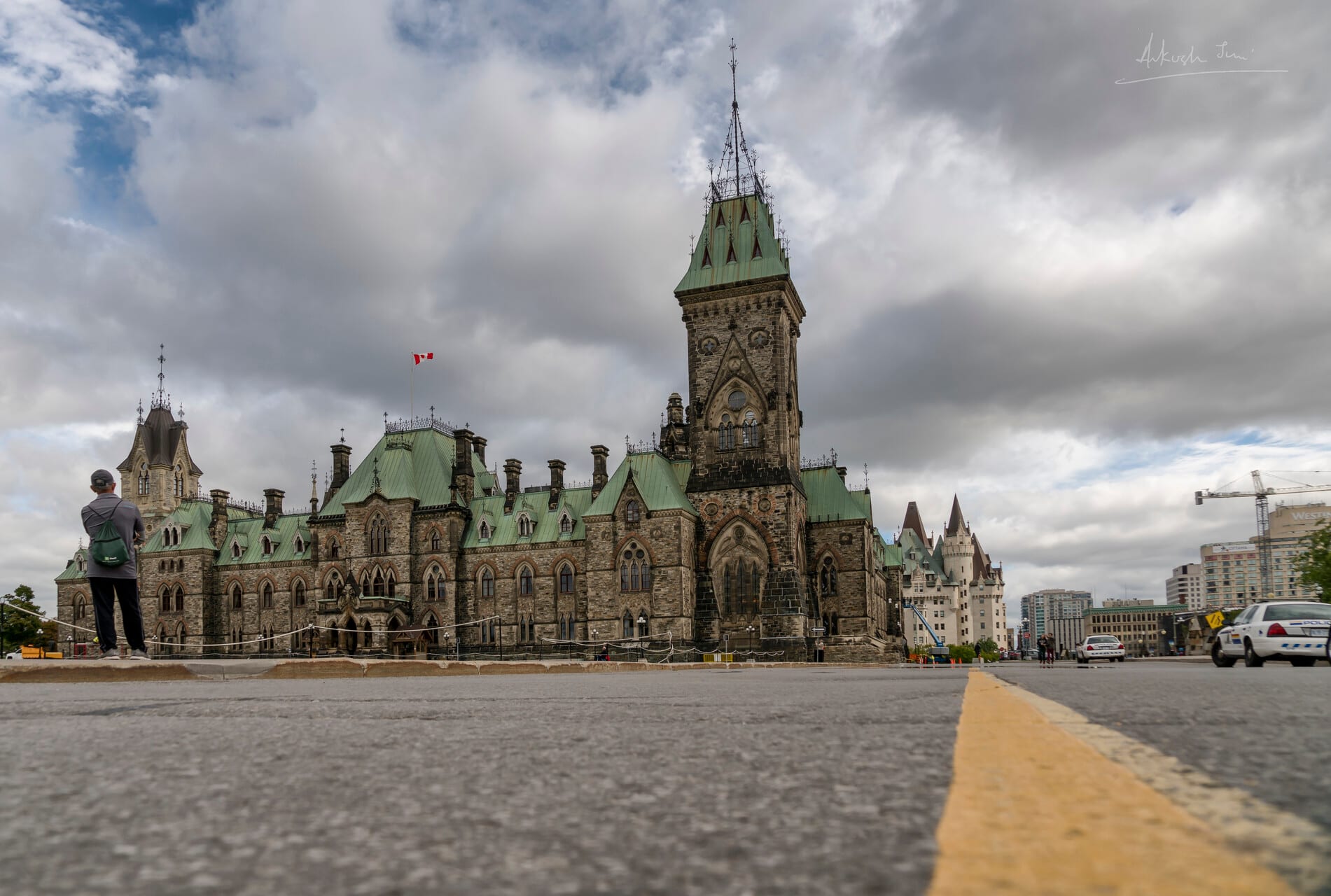 A lone visitor before the East Block of Parliament Hill, Ottawa, on a cloudy day