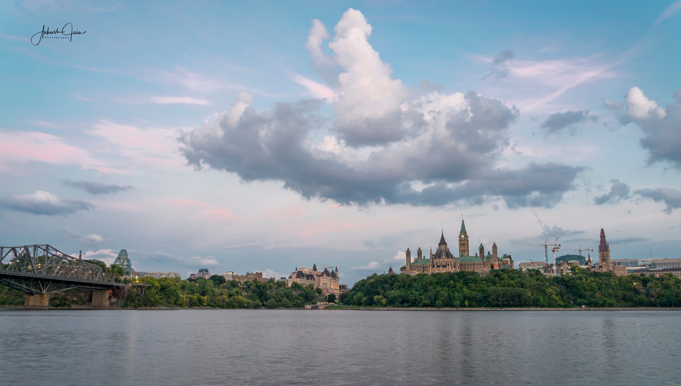 Pastel sunset over Parliament Hill across the Ottawa river, Alexandra Bridge to the left