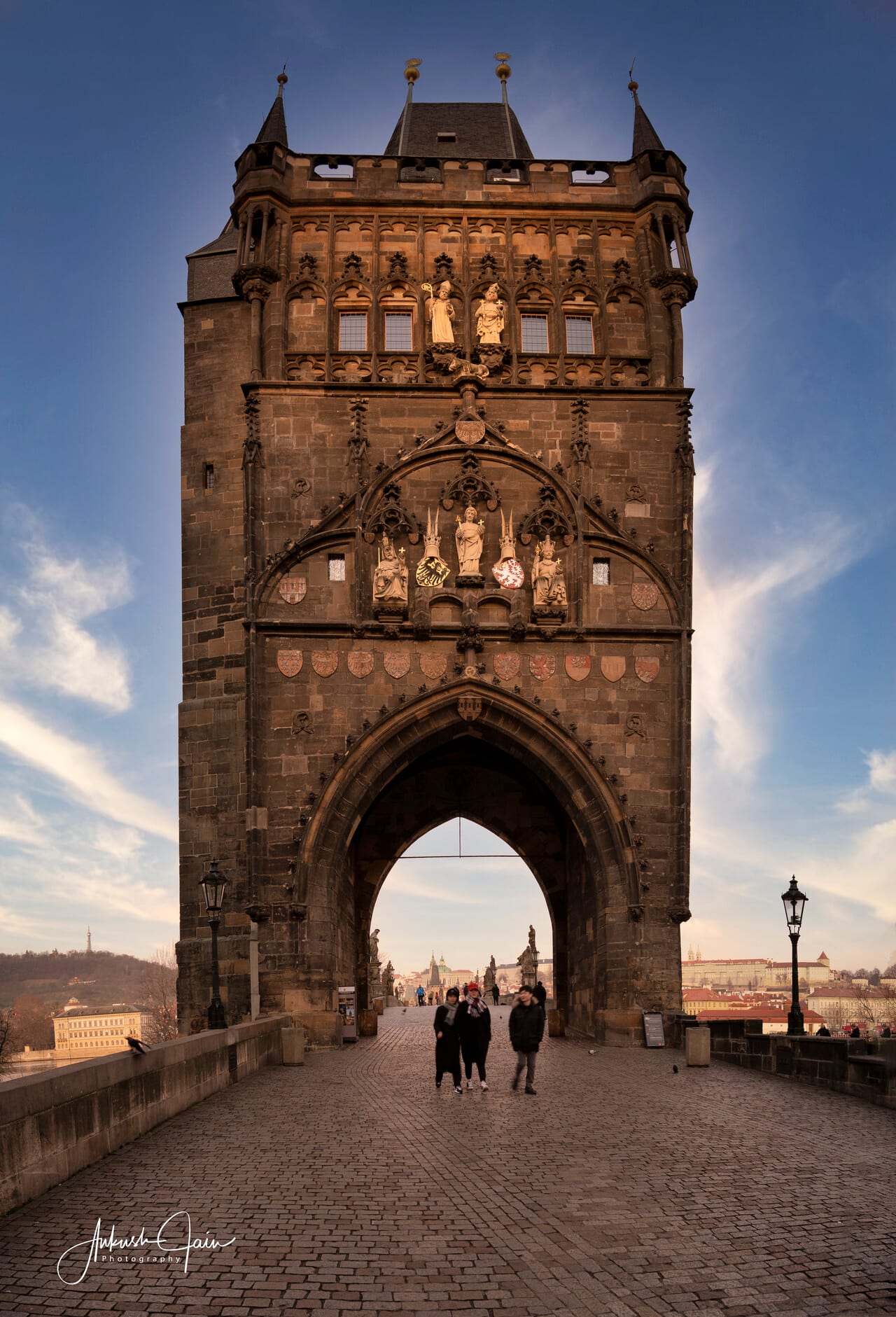 Old Town Bridge Tower of Charles Bridge framing distant figures in its gothic arch