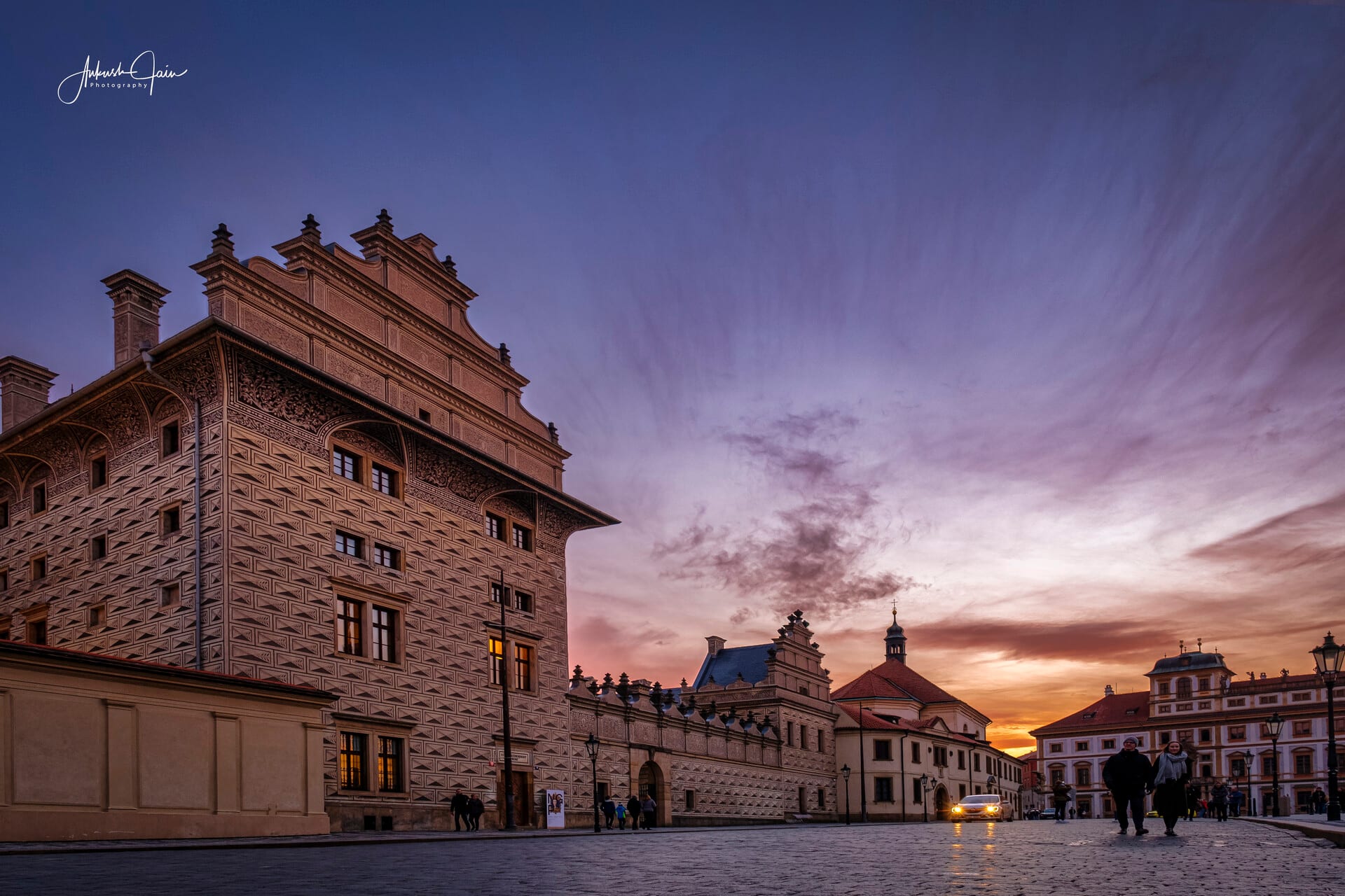 Schwarzenberg Palace with its sgraffito facade rising over Hradčanské náměstí at sunset