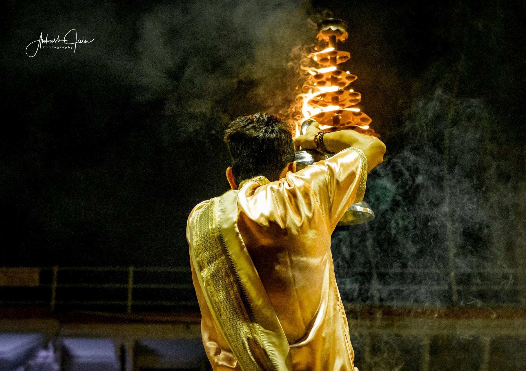 Pandit holding a tiered diya lamp at the Ganga aarti, Dashashwamedh Ghat